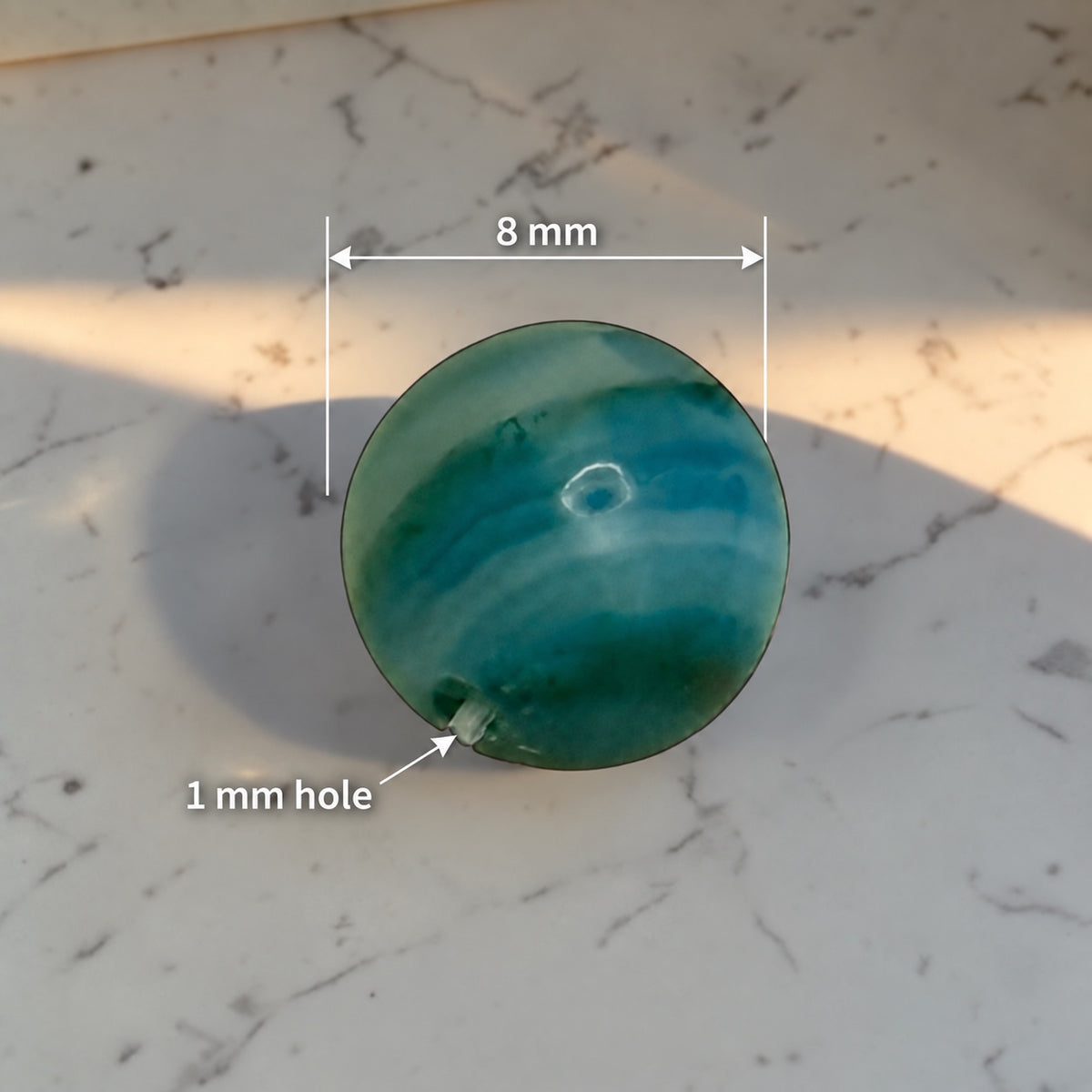 Striped blue agate bead measuring approximately 8 mm with approximately 1 mm hole