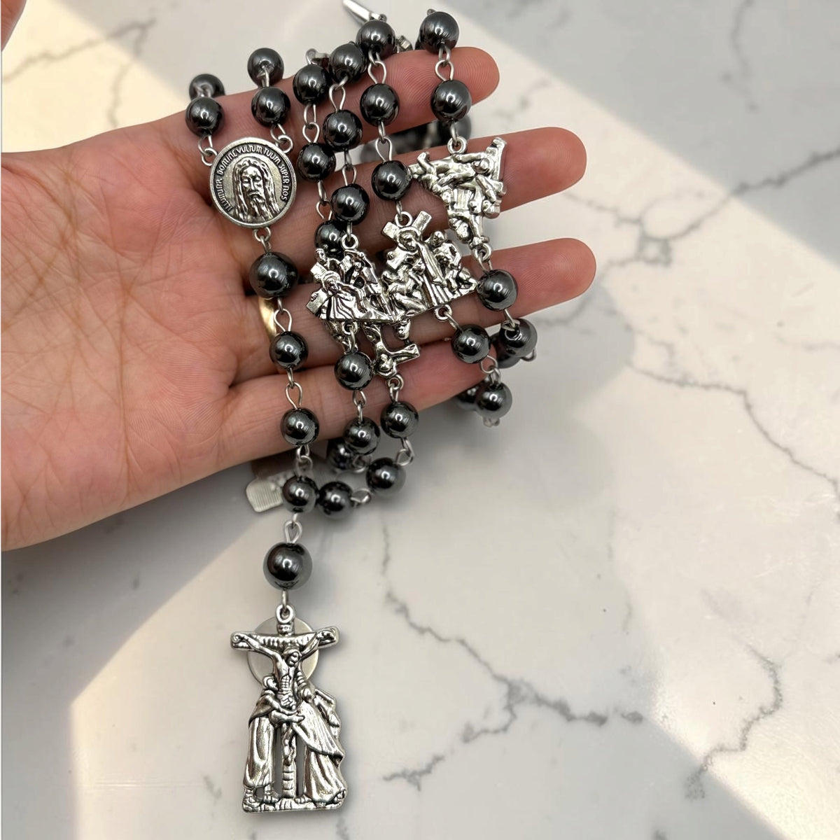 Way of the Cross chaplet with dark gray hematite beads, silver Stations of the Cross medals, Holy Face of Jesus centerpiece, and silver crucifix