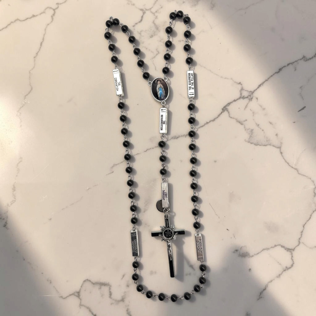 Black and silver Guided Mystery Rosary with glossy black beads, engraved mystery bars, Our Lady of Lourdes centerpiece, and black-and-silver IHS crucifix