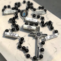 Detailed black and silver Guided Mystery Rosary showing engraved mystery bars, black beads, Our Lady of Lourdes centerpiece, and IHS crucifix