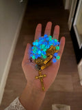 Blue and green glow-in-the-dark beads in hand