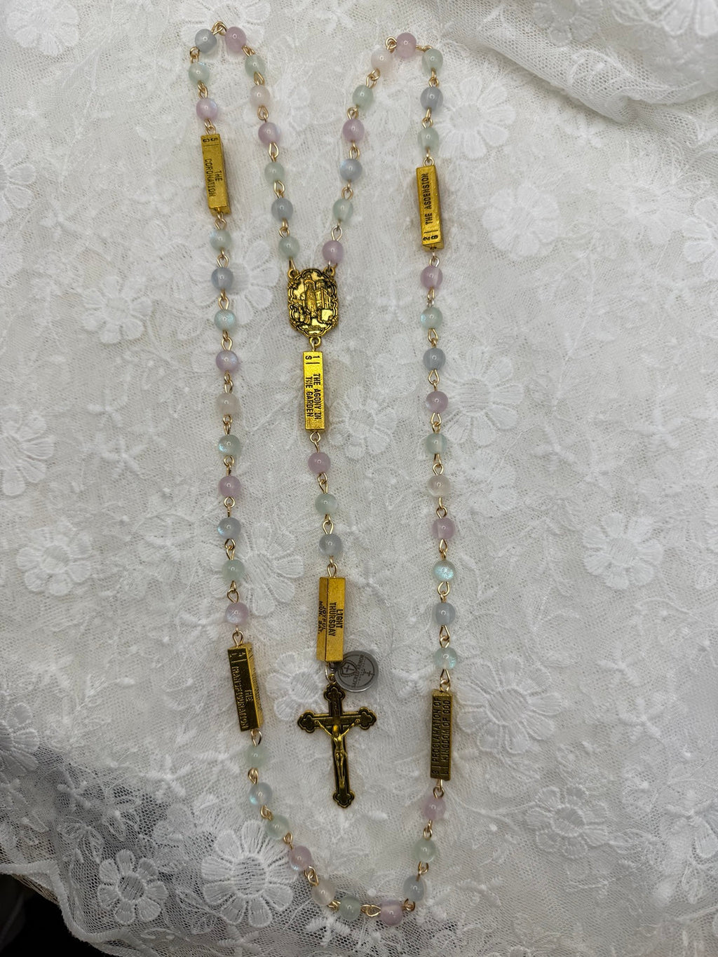 Full view of pastel UV glow rosary with gold mystery bars