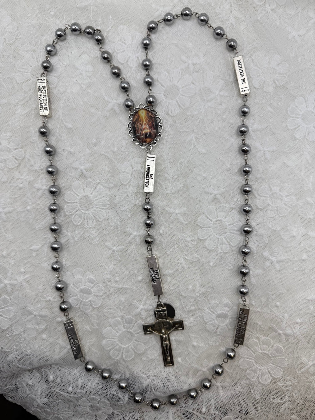 Silver Nativity and hematite rosary, full length view