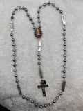 Silver Nativity and hematite rosary, full length view