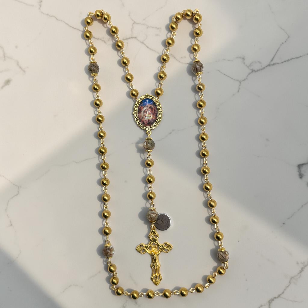Gold Holy Family rosary with marbled glass Our Father beads
