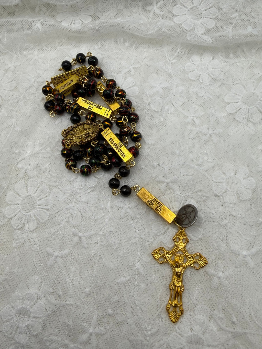 Black multicolor gold rosary detail