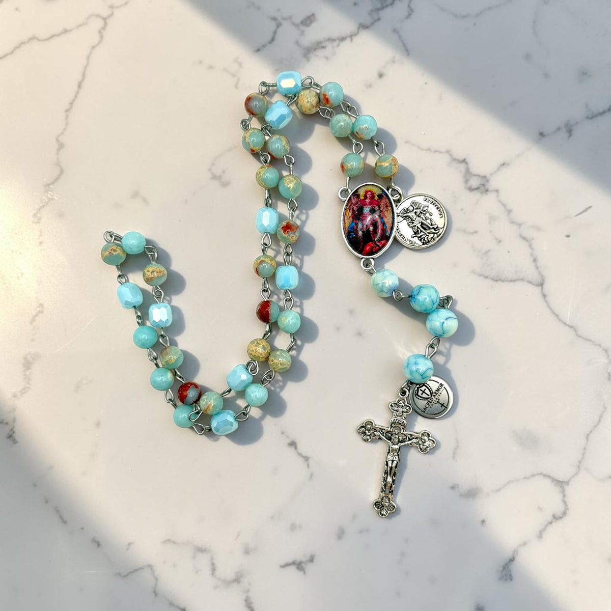 Aqua St. Michael Chaplet angled view with crucifix and centerpiece
