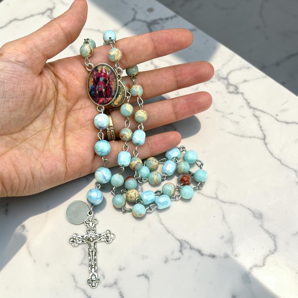 Aqua St. Michael Chaplet held in hand for scale