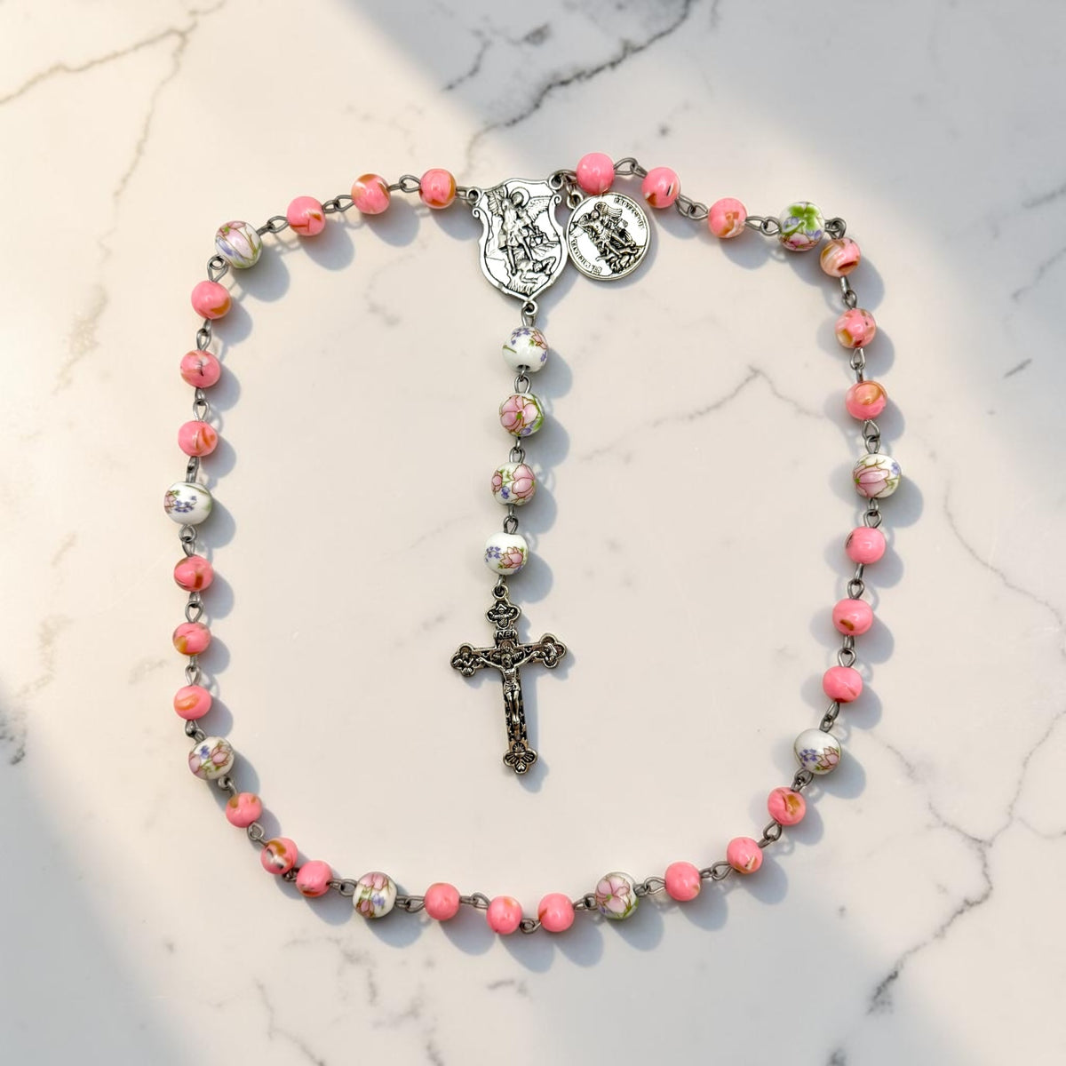Pink floral St. Michael Chaplet full view with silver-tone crucifix