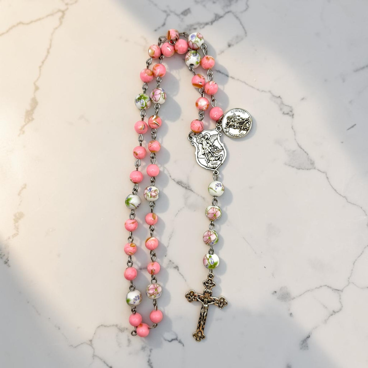 Pink floral St. Michael Chaplet vertical view in natural light