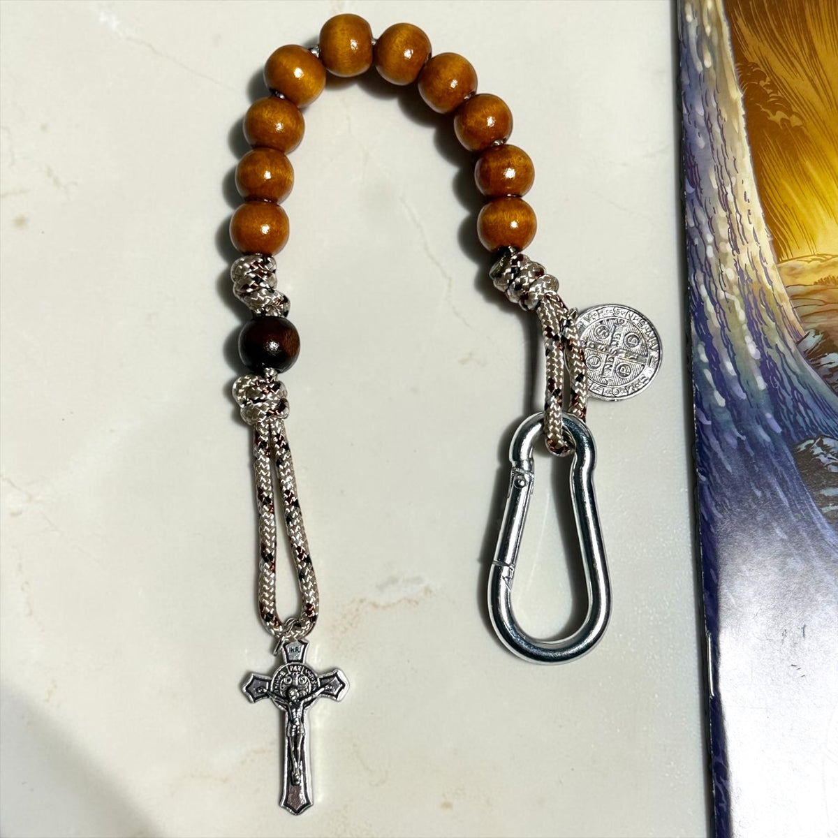 Wooden St. Benedict decade rosary with warm brown beads, silver carabiner, and silver-tone crucifix