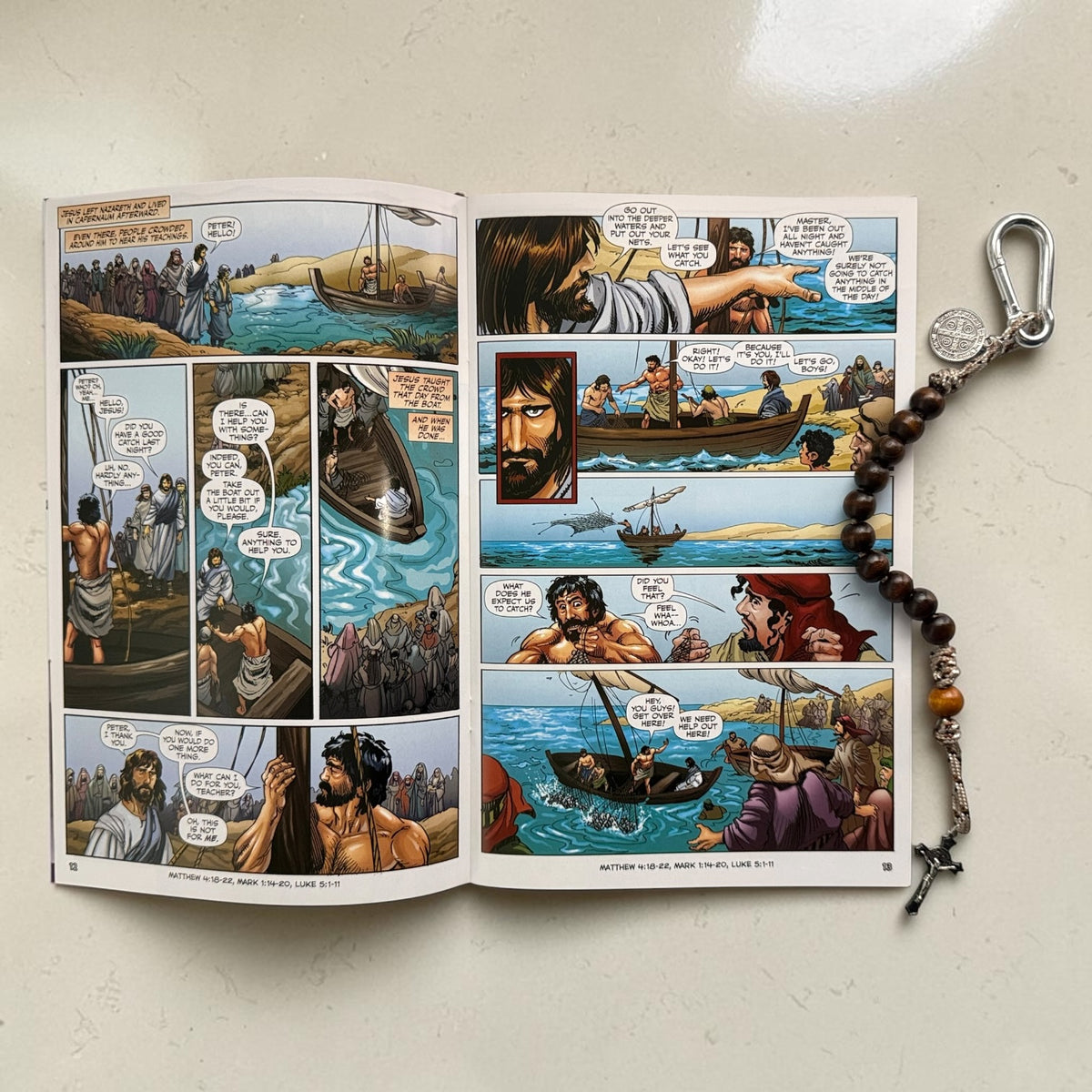 The Christ Volume 4 comic book open to Jesus calling the disciples with wooden St. Benedict decade rosary