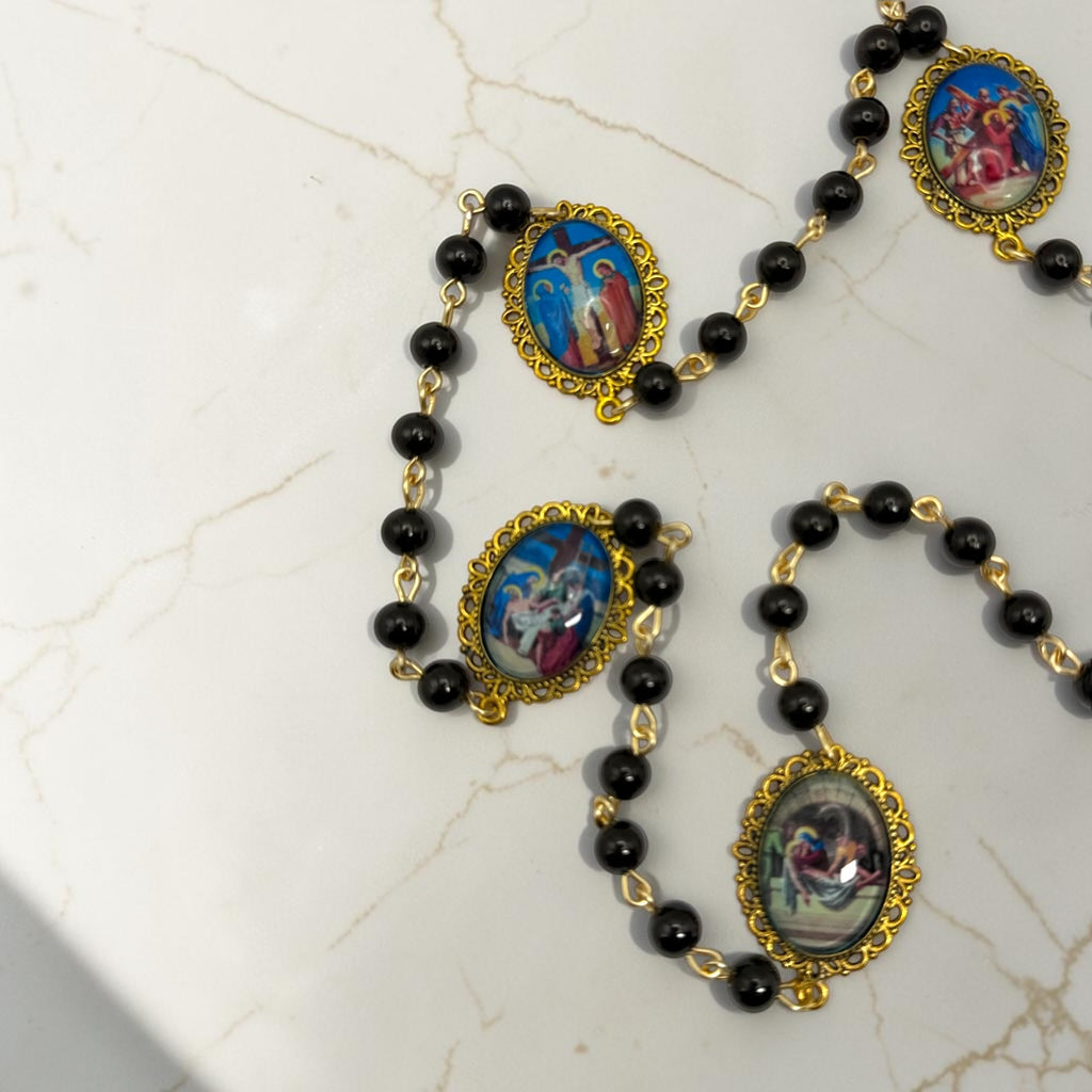 Close-up of Our Lady of Sorrows chaplet showing cabochon glass meditation beads and black beads