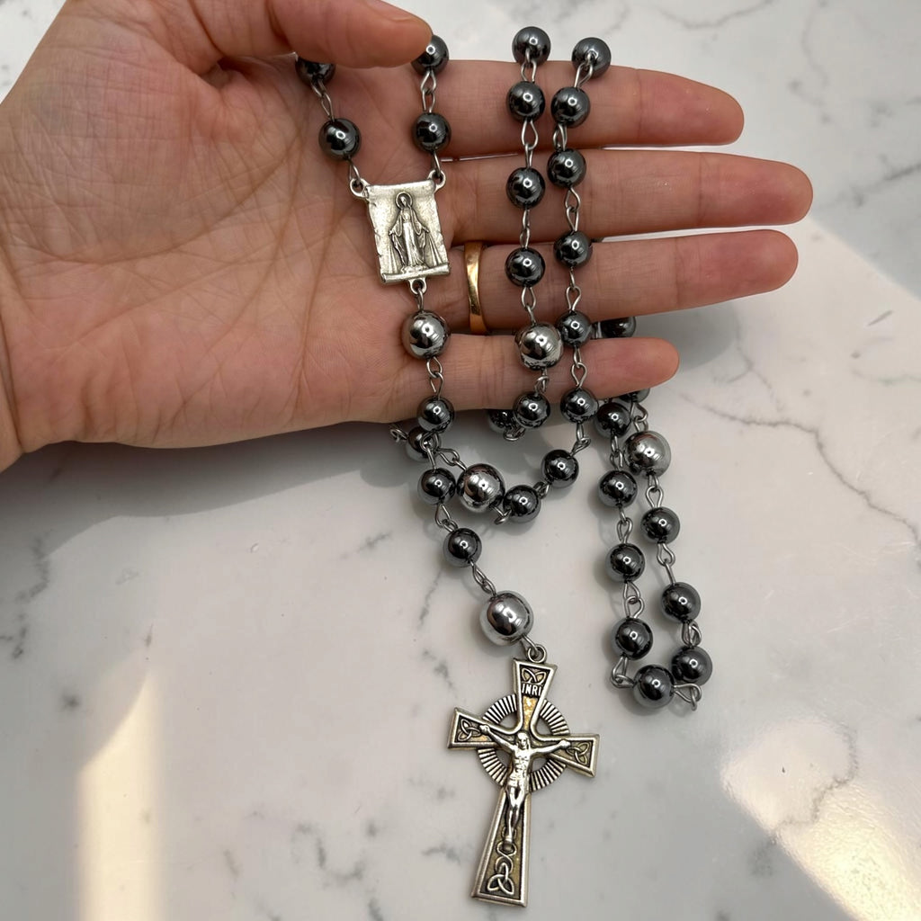 Hand-held dark gray hematite Miraculous Medal rosary with silver-tone chain, larger silver Our Father beads, Marian centerpiece, and ornate silver crucifix