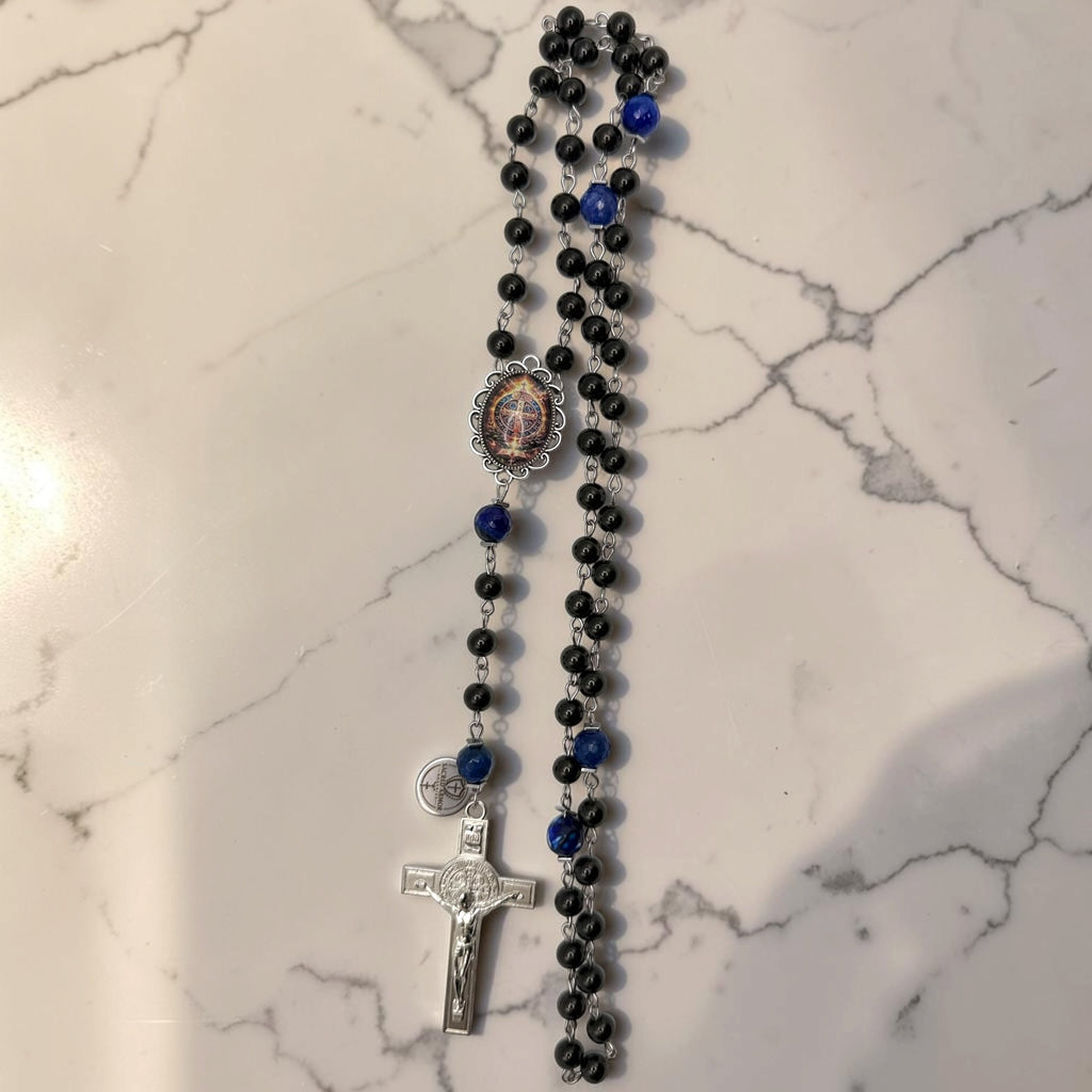 Full black and blue St. Benedict rosary with glossy black beads, deep blue faceted stone accent beads, ornate St. Benedict centerpiece, and silver-tone crucifix