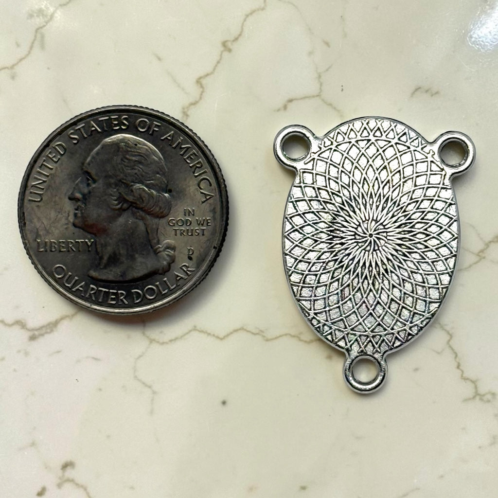 Blue Nativity rosary centerpiece silver-tone patterned back shown beside a quarter