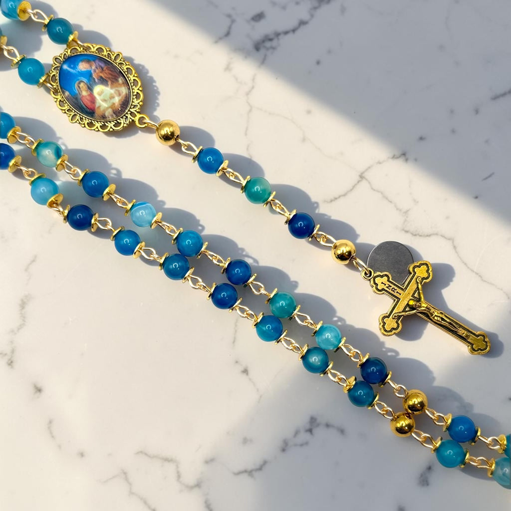 Blue striped agate and gold Holy Night rosary close-up