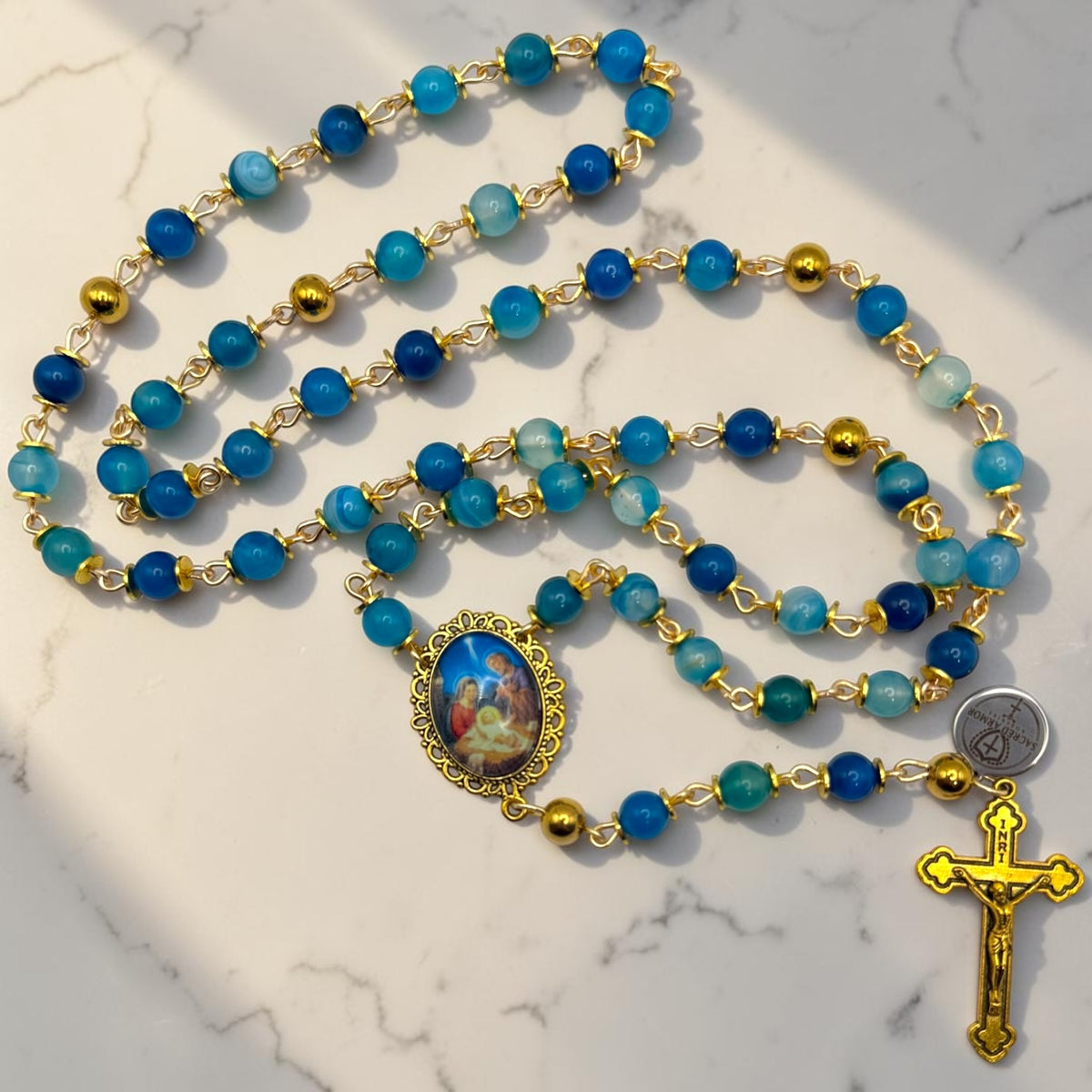 Blue striped agate and gold Holy Night rosary arranged view