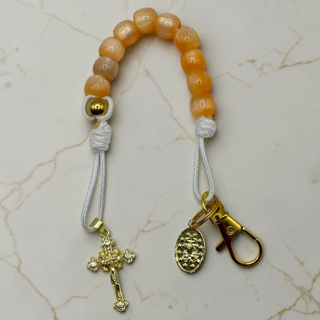 Warm orange bead decade rosary with white cord, gold crucifix, medal and lobster clasp