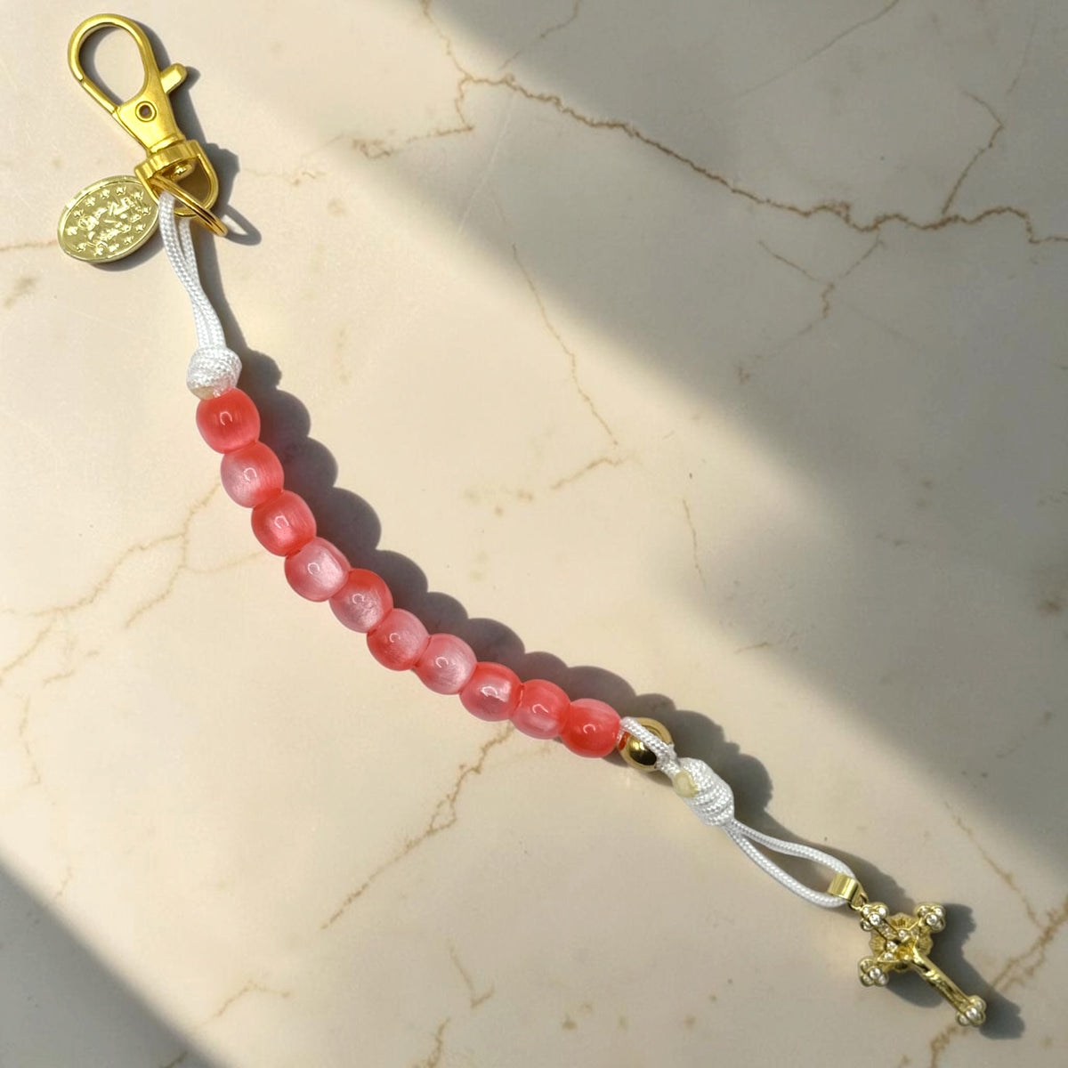 Handmade pink and red decade rosary with white cord and gold-tone Catholic devotional hardware