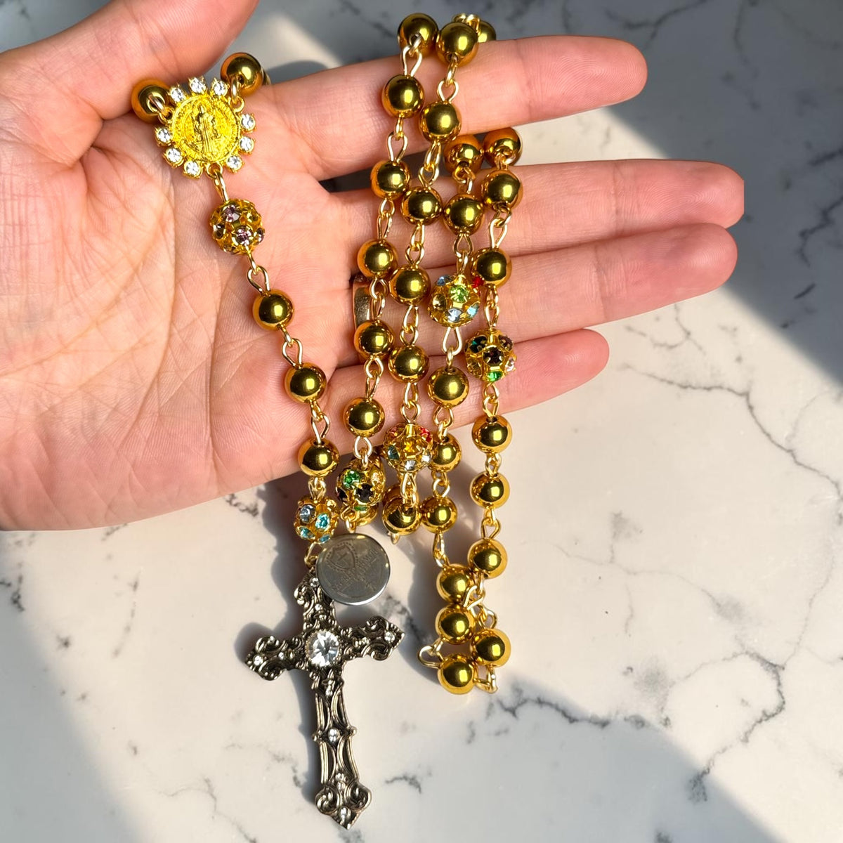Gold Saint Benedict rosary detail view with ornate crucifix