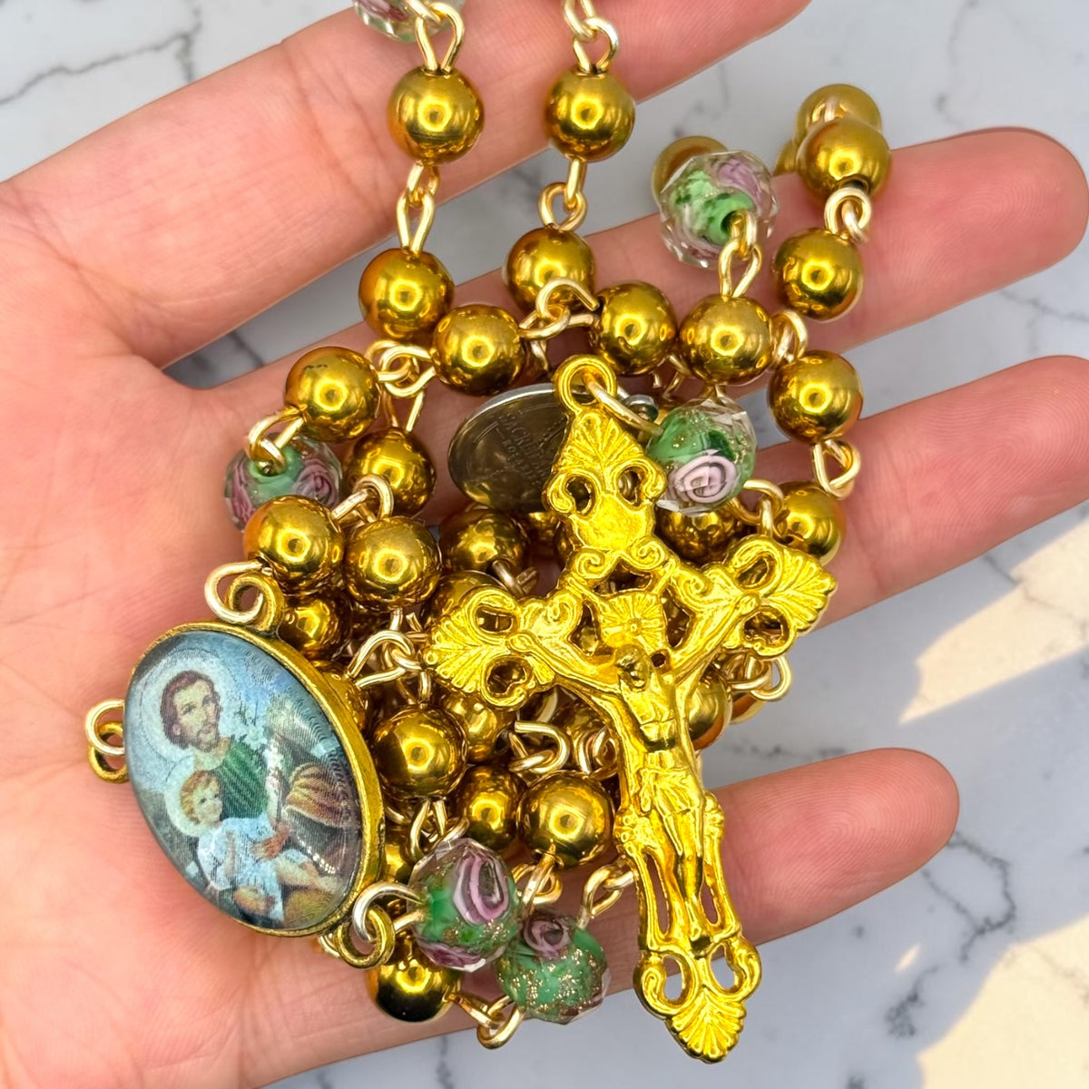 Gold Saint Joseph rosary detail view with floral glass beads