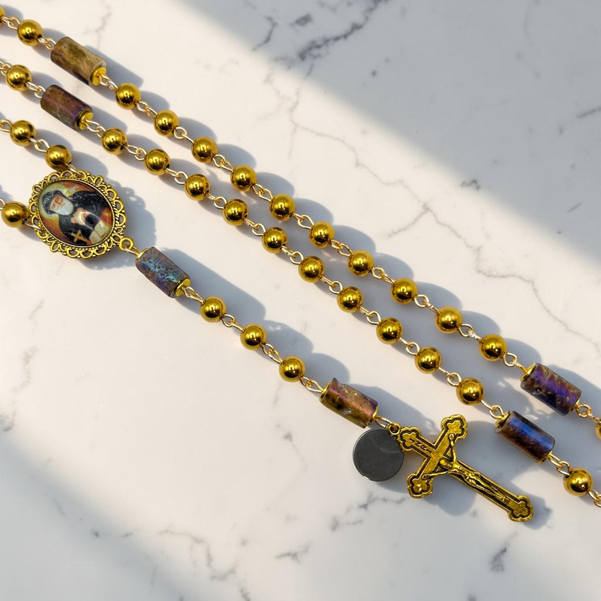 Gold St. Charbel Rosary close-up with iridescent accent beads