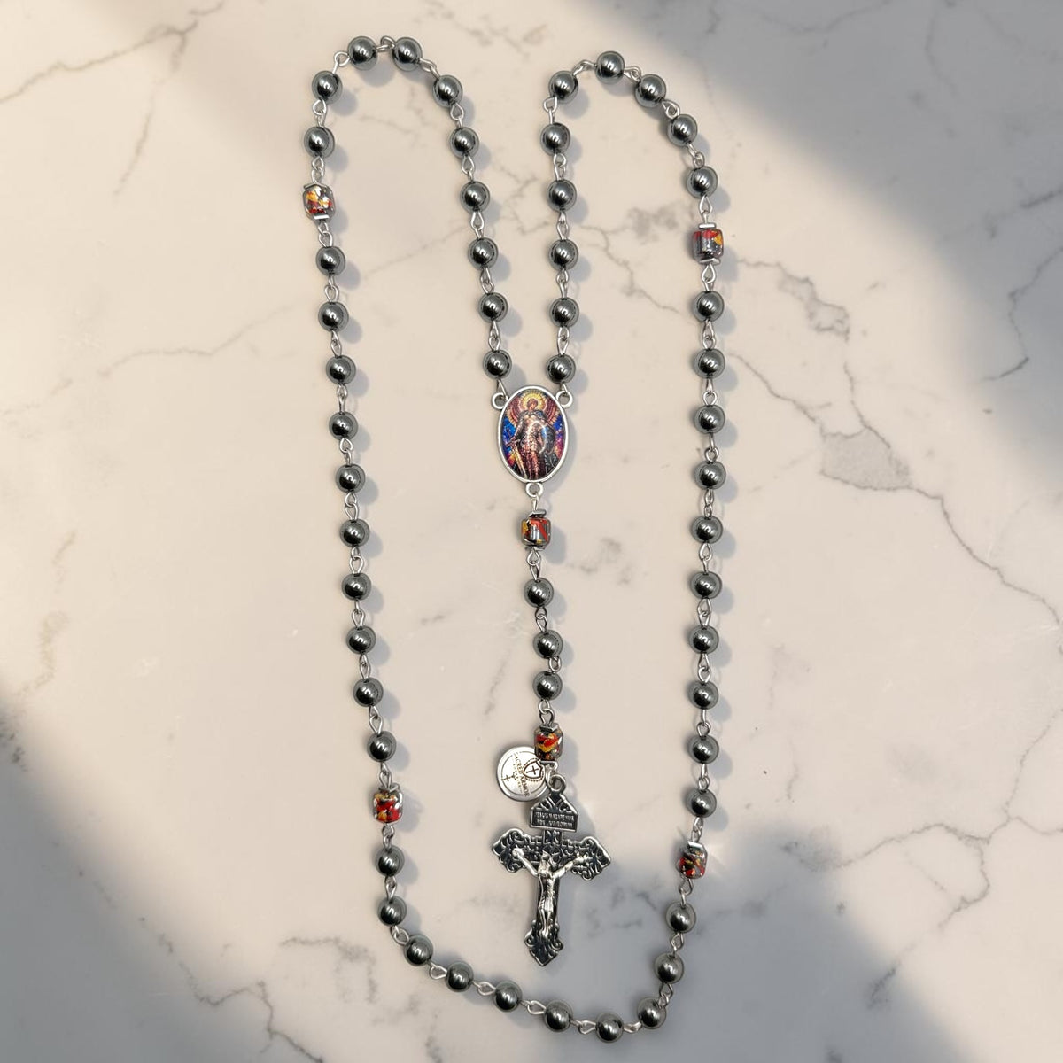 Hematite Saint Michael rosary with paint splatter Our Father beads full view