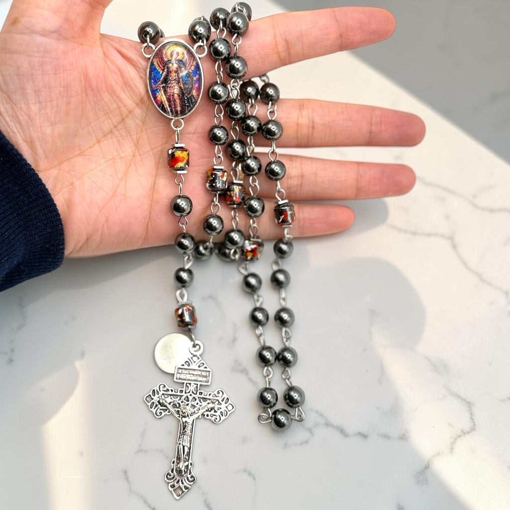 Hematite Saint Michael rosary shown in hand
