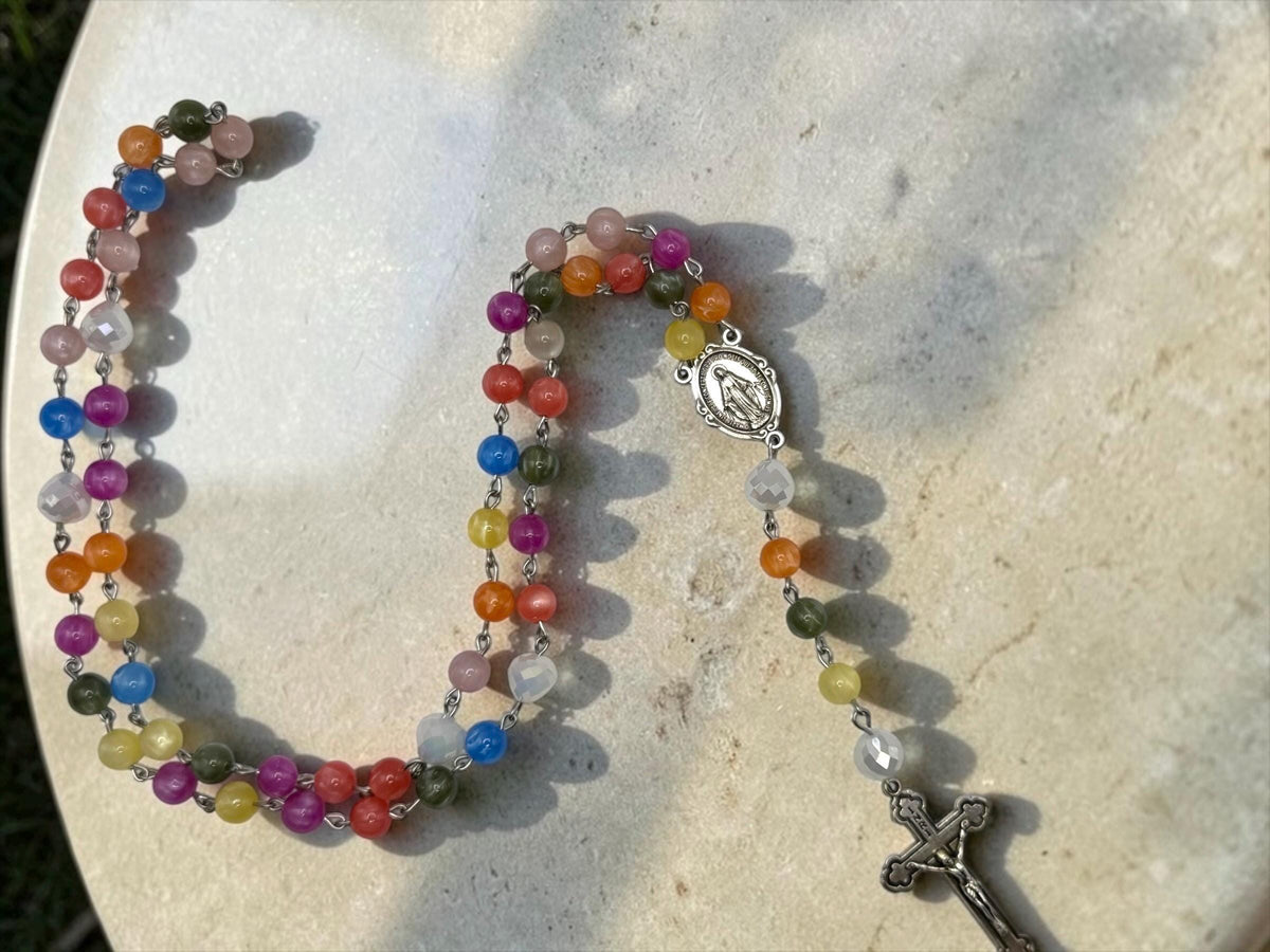 Miraculous Medal detail on sunlight color-changing Rosary