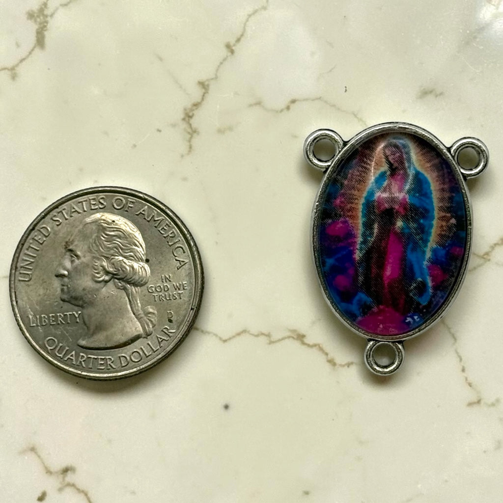 Our Lady of Guadalupe glass cabochon rosary centerpiece shown beside a quarter for scale