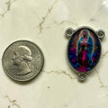 Our Lady of Guadalupe glass cabochon rosary centerpiece shown beside a quarter for scale