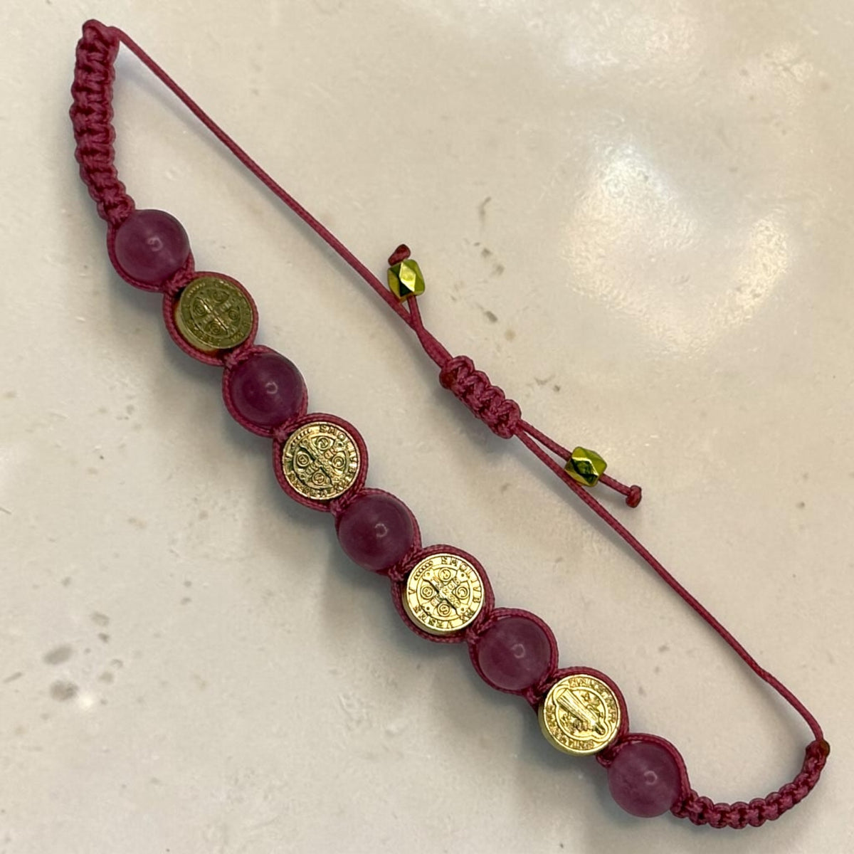 Pink cord Catholic bracelet with translucent pink beads and gold Saint Benedict medals