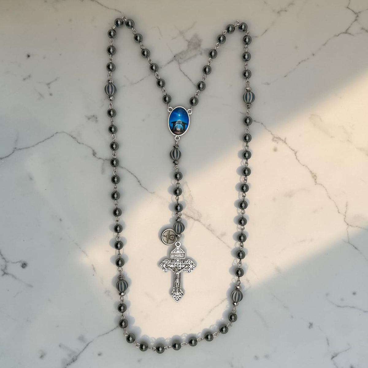 Dark gray hematite Catholic rosary with striped glass Our Father beads and Holy Night Nativity centerpiece