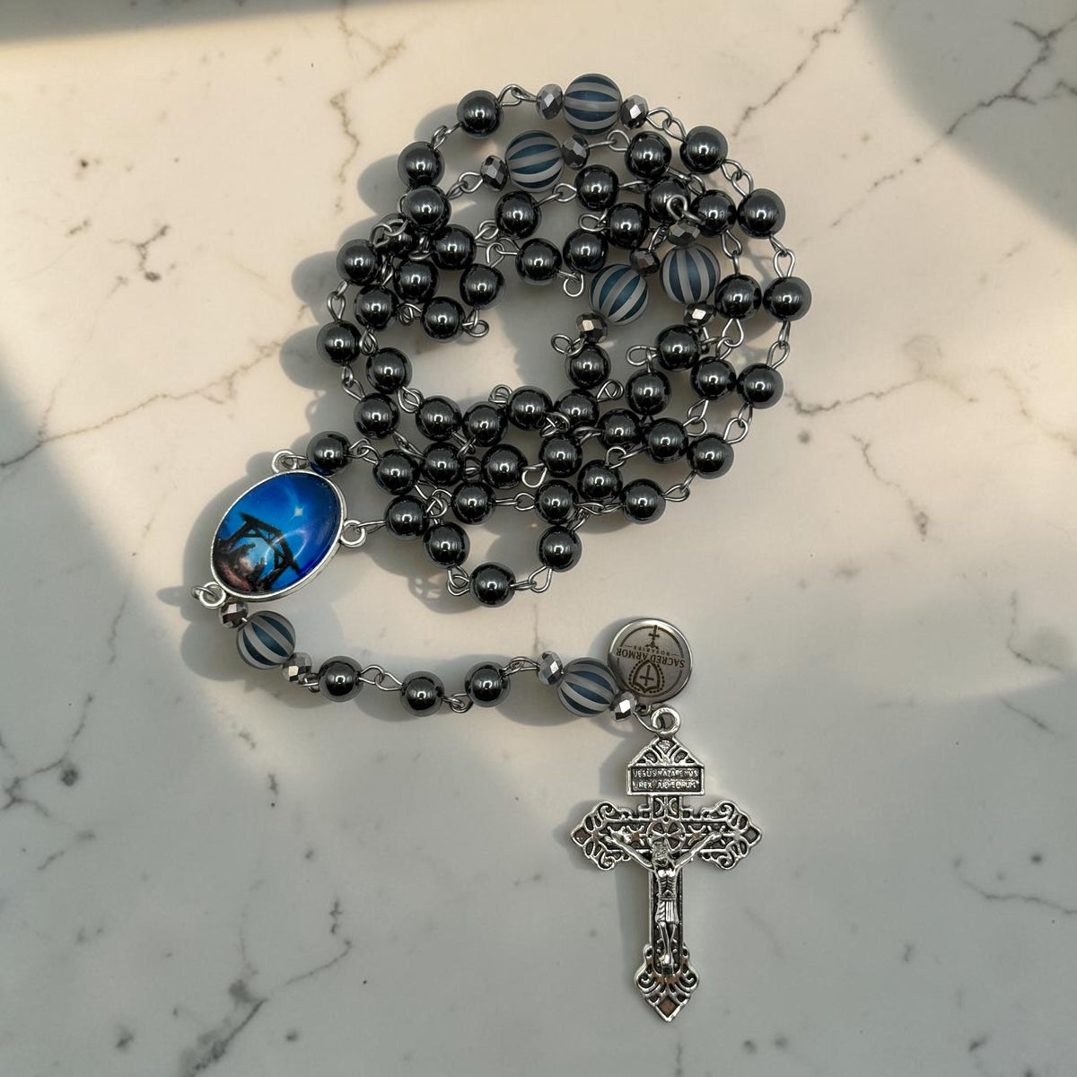 Handmade dark gray hematite rosary arranged with silver crucifix and Holy Night Nativity centerpiece