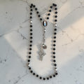 Black Catholic rosary with silver-tone beads, Our Lady of Lourdes centerpiece, and ornate silver crucifix
