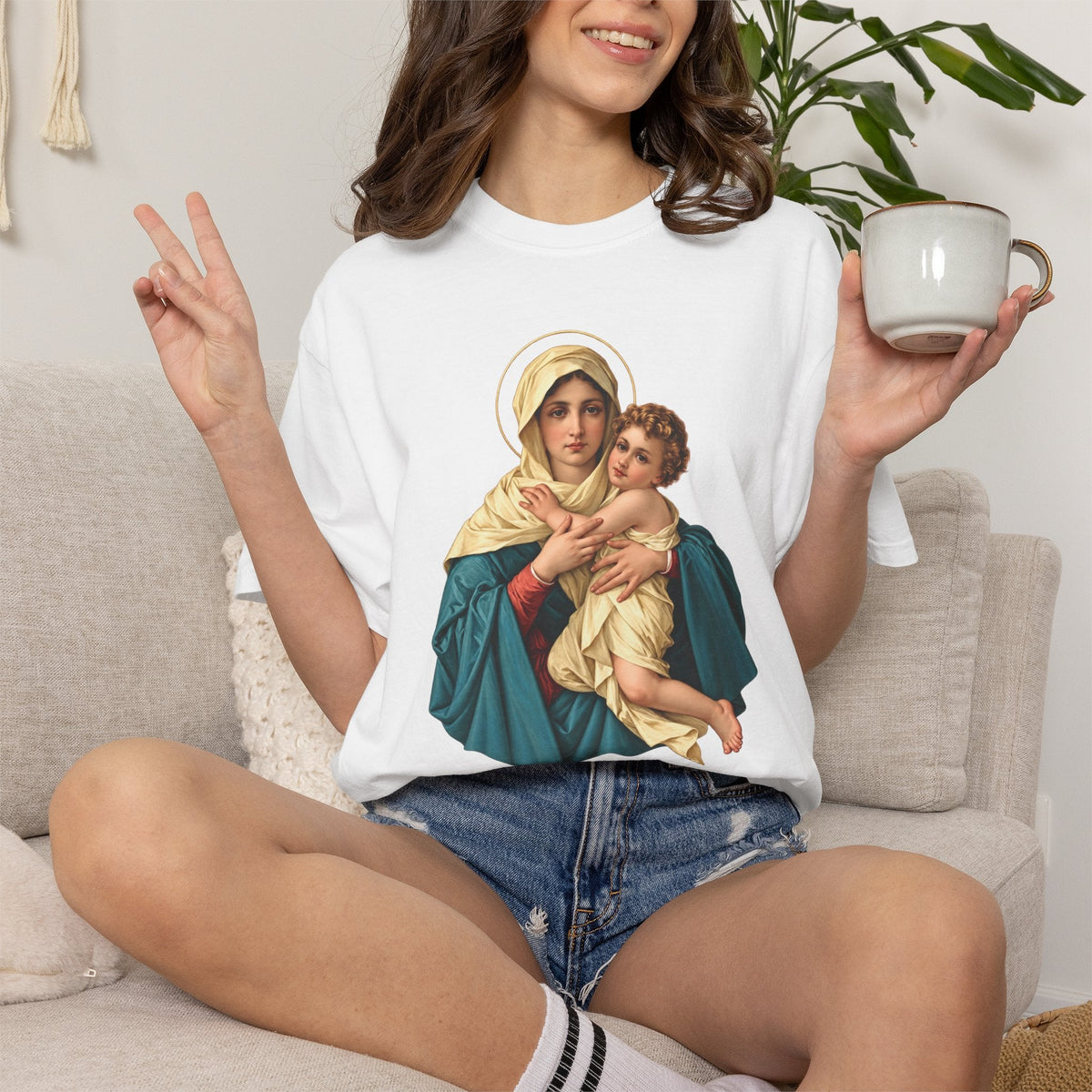 Sacred Armor Rosaries white Comfort Colors t-shirt featuring a vibrant Our Lady of Schoenstatt print on a woman