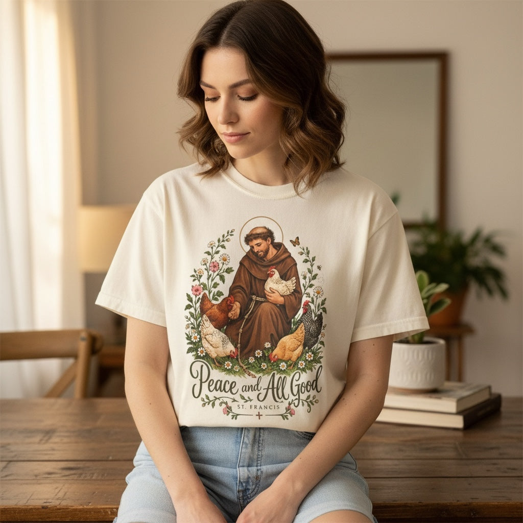 Woman wearing cream St. Francis of Assisi Peace and All Good T-shirt indoors